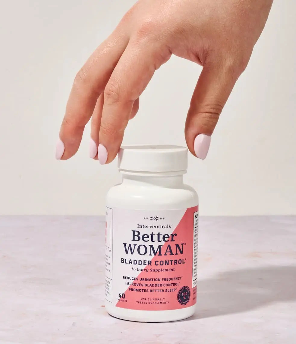 Hand holding a bottle of Interceuticals Better Woman Bladder Control supplement, formulated to support urinary health, bladder control, and sleep quality.