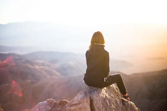 A woman looking out the mountains