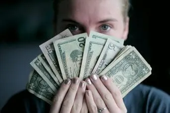 A person holding cash