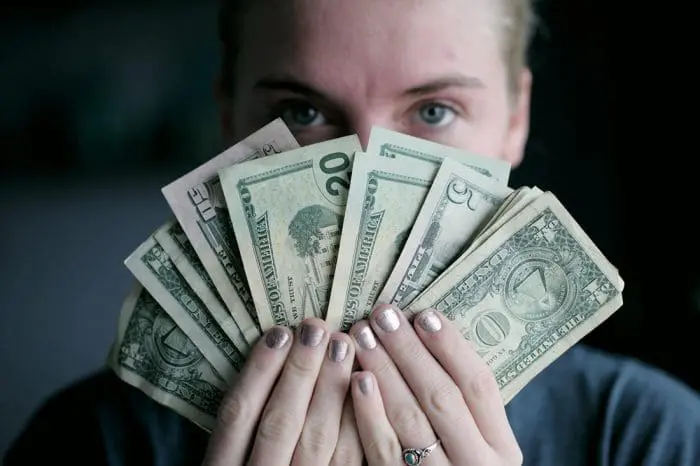 A person holding cash