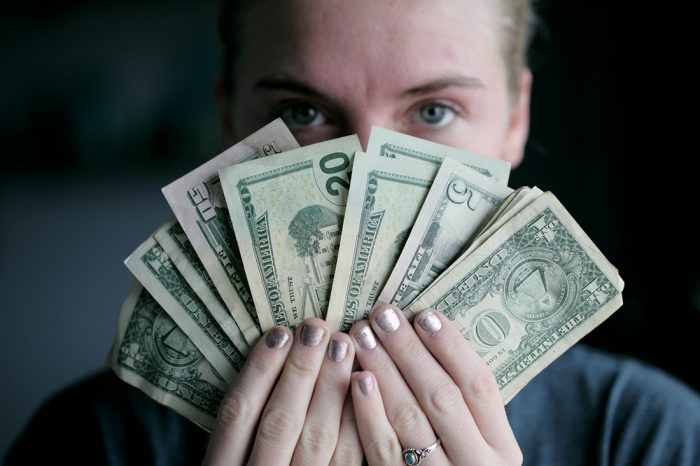 A person holding cash